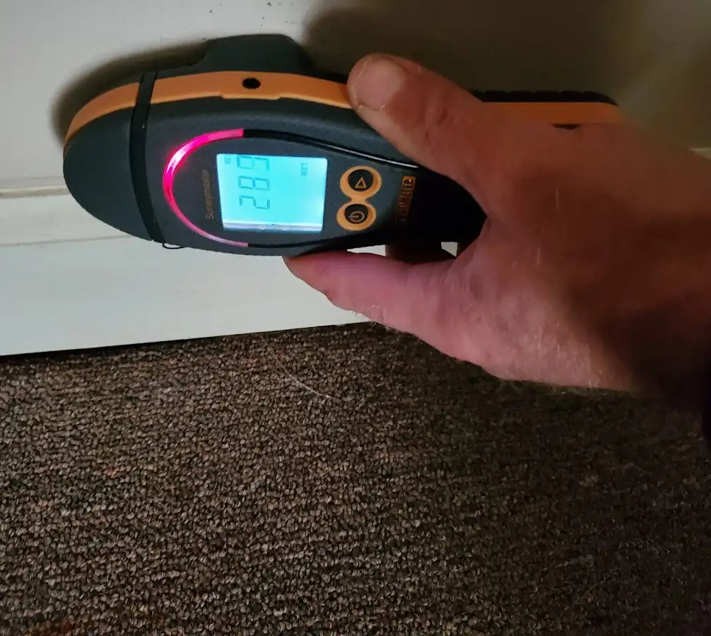 Moisture detection at baseboard during Storm Damage Restoration in Babylon